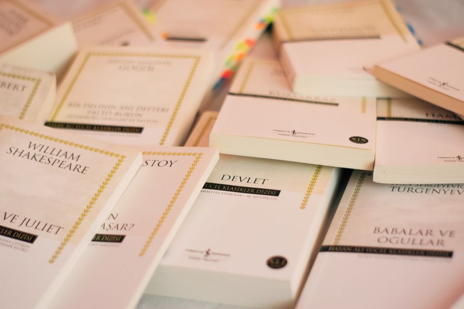 An open hymn book with musical notes laying on earthy ground, featuring sheet music and lyrics.
